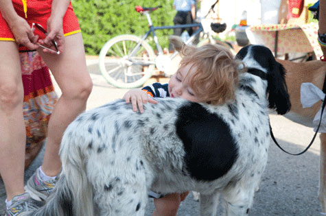 baby hugging dog